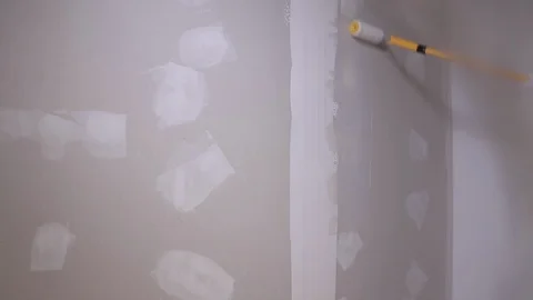 The Builder Hand Strikes The Primer On The Plaster Wall Stock Footage 101388767