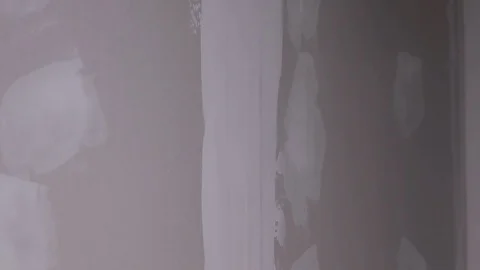 The Builder Hand Strikes The Primer On The Plaster Wall Stock Footage 101388810