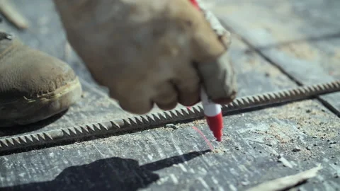 Builder hands in gloves making marks with a marker Stock Footage 255649513