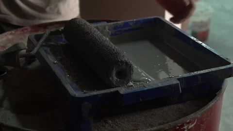 Builder, hard worker, handyman. Roller for plastering walls in solution. Cons Stock Footage 148221259