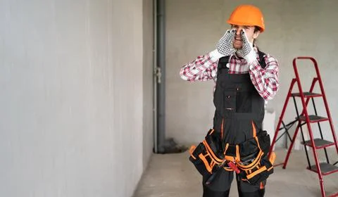 Builder in hardhat shouting while working at construction site during renovat Stock Photos