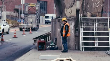 Builder is having a rest on the street Stock Footage 85434682