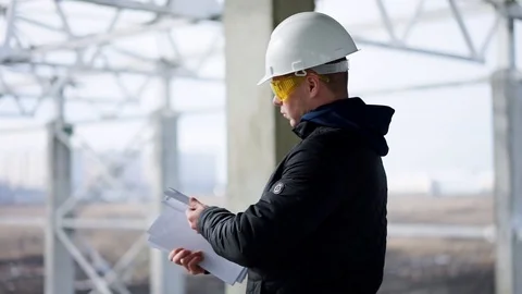 Builder in a helmet on construction object Stock Footage 89707326