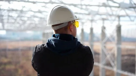 Builder in a helmet on construction object Stock Footage 89707370