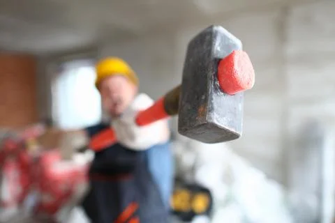 Builder holding a construction hammer at construction site closeup Stock-Fotos