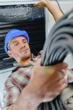 Builder holding roll of cable Stock Photos