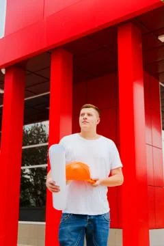 Builder holds in hand the plan Stock Photos