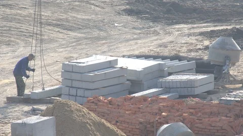 Builder hooks slings on a concrete beam. Construction crane Video stock 120675081