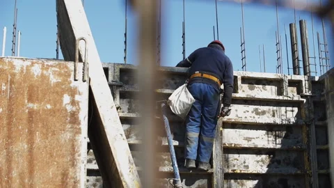 Builder installs formwork on a construction site Stock Footage 268692908