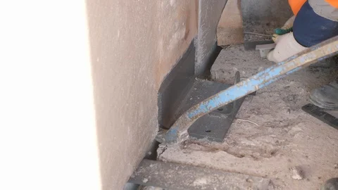 Builder installs mount to wall panel and colleague helps Stock Footage 125930459