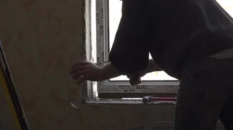 Builder installs a new window. Double glazing. 4K. Stock Footage 62305074