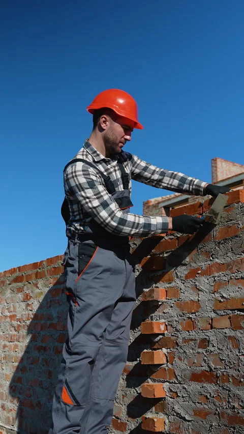 Builder Laying Bricks at Construction Site Stock Footage 297310505