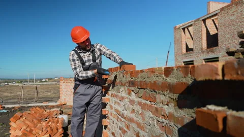 Builder Laying Bricks During Cottage Construction Stock Footage 297303894