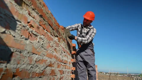 Builder Laying Bricks for House Construction Stock Footage 297303670