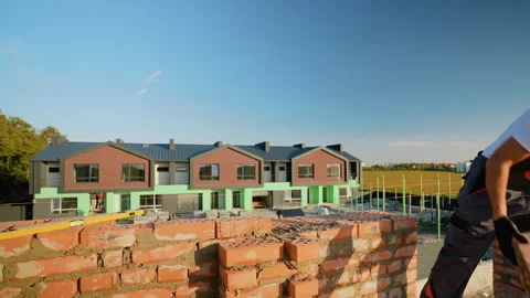 Builder Laying Bricks for Modern Residential Complex Stock Footage 293639026