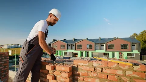 Builder Laying Bricks for Modern Townhouse Construction Stock Footage 293638939