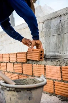 Builder laying bricks in site. Stock Photos