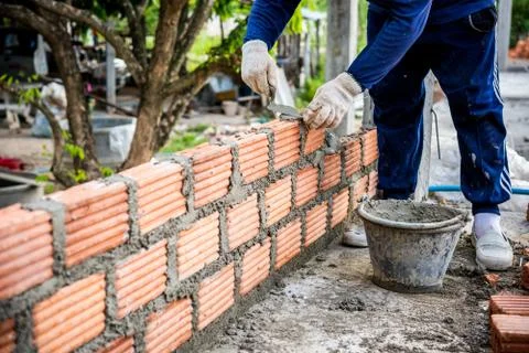 Builder laying bricks in site. Stock Photos