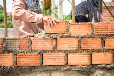 Builder laying bricks in site. Stock Photos