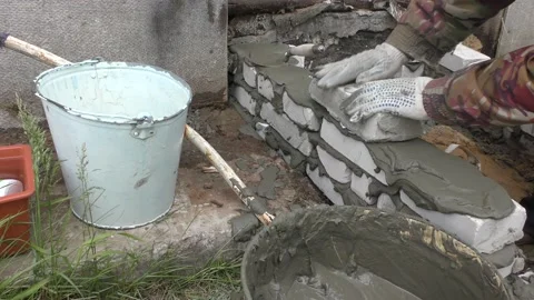 The Builder is laying bricks on the solution Stock Footage 136639433