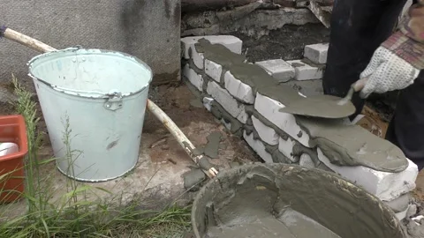 The Builder is laying bricks on the solution Stock Footage 136639591