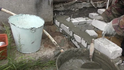 The Builder is laying bricks on the solution Stock Footage 136640224
