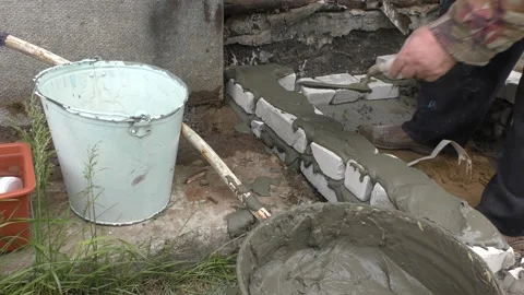 The Builder is laying bricks on the solution Stock Footage 136640396