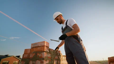 Builder Laying Bricks at Townhouse Construction Site Stock Footage 293639677
