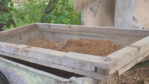 Builder laying a paving brick placing it on the sand foundation with gloved Stock Footage 112432909