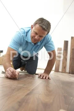 Builder Laying Wooden Flooring Stock Photos