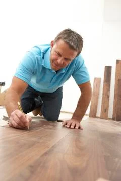 Builder Laying Wooden Flooring Stock Photos