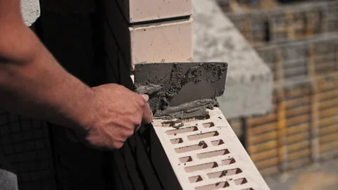 Builder lays a brick wall at a construction site. Stock Footage 244391718