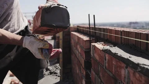 A builder lays a brick wall Stock Footage 219936676