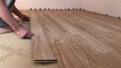 The builder lays down the laminate in the apartment. Stock Footage 160915247