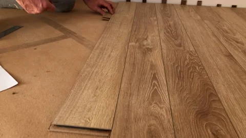The builder lays down the laminate in the apartment. Stock Footage 160916917