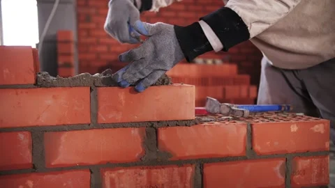 Builder lays red brick close-up Stock Footage 168356511
