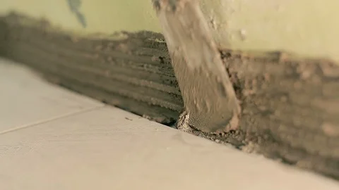 Builder lays a small tile Видео 90983930