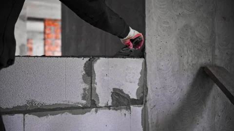 Builder lays a wall of blocks Stock Footage 241042039