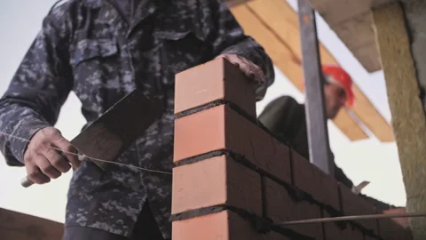 Builder lays a wall of bricks Stock Footage 237450950