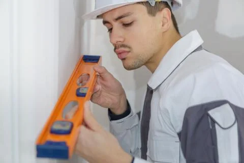Builder with level Stock Photos