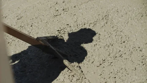 Builder leveling liquid concrete at the construction site Stock Footage 287633655