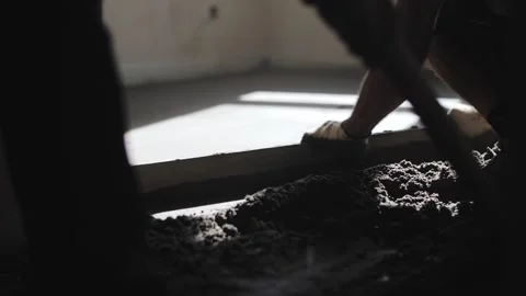 Builder levels floors with sand Stock Footage 218232672