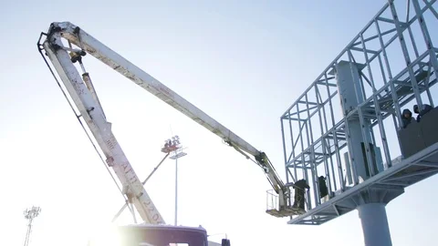 Builder on a Lift Platform at a construction site. Men at work. construction Vídeos de archivo 84558395