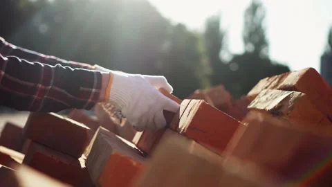 Builder loader shifts bricks blocks stacking red bricks on a pallet for furt Stock Footage 197488432