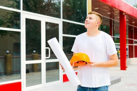 Builder looking at a building with a smile Stock Photos