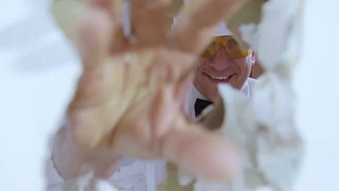 The builder looks through the hole in the wall. Stock Footage 81356541