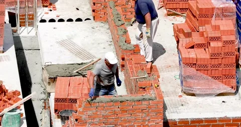 The builder makes a corner of the wall on a high-rise building Stock Footage 137086557