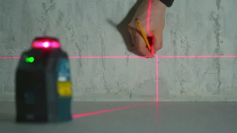 Builder makes markings using laser level. Stock Footage 170940084