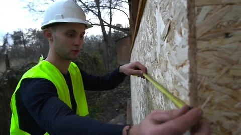 The builder makes measurements close-up Stock Footage 75619313
