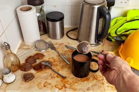 Builder making a cup of tea in his dirty kitchenette Stock Photos